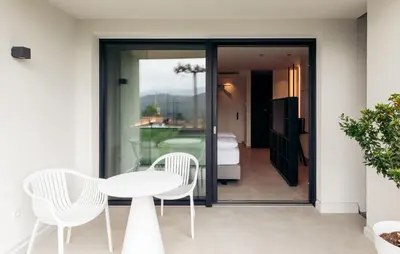 a white table and two chairs on a balcony at Villa Weingarten in Caldaro