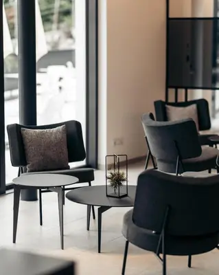 a group of chairs and tables in a room at Villa Weingarten in Caldaro