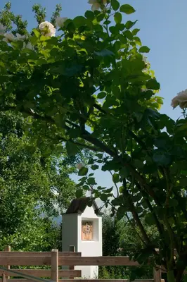 a small bird house behind a wooden fence at Pension Angergut in Cermes