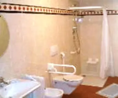 a bathroom with a shower and a toilet and a sink at Pension Angergut in Cermes