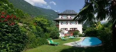 a house with a swimming pool next to a building at Pension Angergut in Cermes