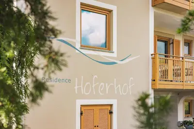 a building with a sign that reads residence hacienda at Residence Hoferhof in Lana