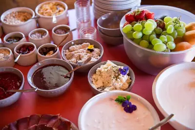 a table topped with bowls of different types of food at Das Bergland - Vital & Activity in San Leonardo in Passiria