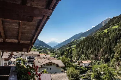 a view of a town in a valley with mountains at Das Bergland - Vital & Activity in San Leonardo in Passiria