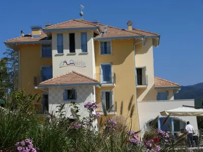 a yellow building with a sign on it at La Quiete Resort in Romeno