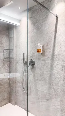 a shower with a glass door in a bathroom at Hotel La Montanara Predazzo in Predazzo
