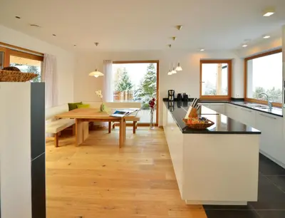 a kitchen and dining room with a wooden table at Apartmenthaus Fuchsmaurer in Bressanone