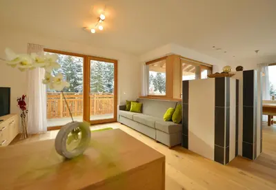 a living room with a couch and a refrigerator at Apartmenthaus Fuchsmaurer in Bressanone