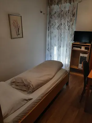 a bed in a room with a window at B&B Hotel Dolomiti in Bolzano
