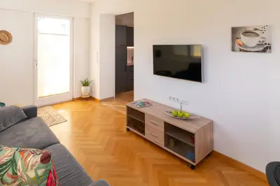 a living room with a couch and a flat screen tv at Apartment Haus Lang in Lagundo