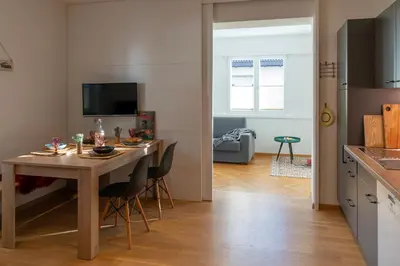 a kitchen and dining room with a table and chairs at Apartment Haus Lang in Lagundo