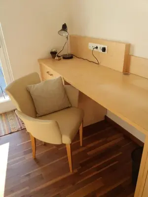 a wooden desk with a chair and a lamp at Apartment Haus Lang in Lagundo