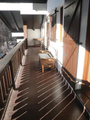 a balcony with benches and a table in a building at I mughi - Cortina in Cortina dʼAmpezzo