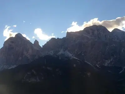 a mountain range with clouds in the sky at I mughi - Cortina in Cortina dʼAmpezzo