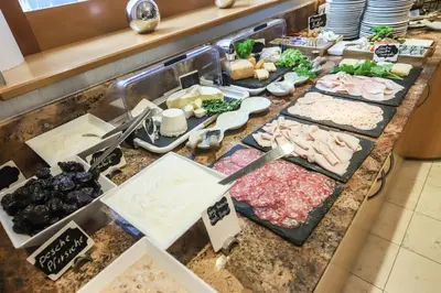a buffet with many different types of food on a counter at Hotel Villa Groff in Ora/Auer
