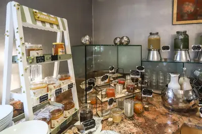 a room with a counter with many jars of food at Hotel Villa Groff in Ora/Auer