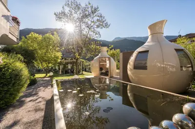 two large vases sitting on top of a glass table at Hotel Villa Groff in Ora/Auer