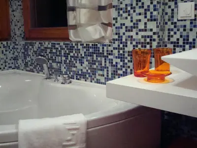 a bathroom with two vases sitting on a sink at Villa Moroder in Ortisei