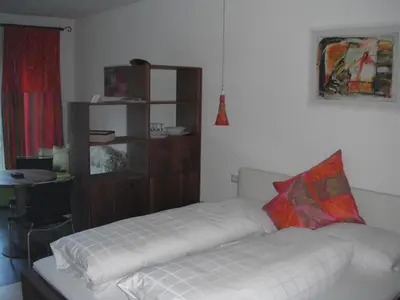 a living room with a white couch and a shelf at Villa Moroder in Ortisei