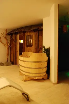 a room with a bath tub in the corner of a room at Villa Moroder in Ortisei
