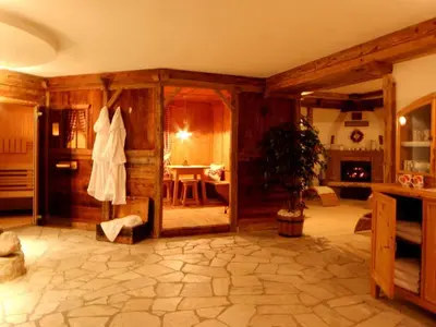 a large living room with a room with at Dolomites Apartments Ciasa Vally in San Cassiano