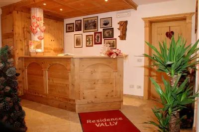 a kitchen with a wooden island in a room at Dolomites Apartments Ciasa Vally in San Cassiano