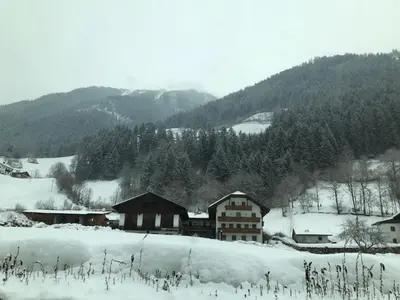 a group of houses in a snow covered mountain at Hotel Pension Moarhof in Vallarga