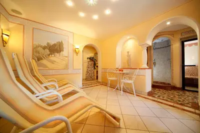 a living room with chairs and a table in it at Residence Ulrike in Nova Levante
