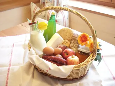 a basket of food with eggs eggs bread and milk at Lehrnerhof Lüsen in Luson