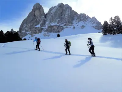 three people skiing in the snow in front of a mountain at Lehrnerhof Lüsen in Luson