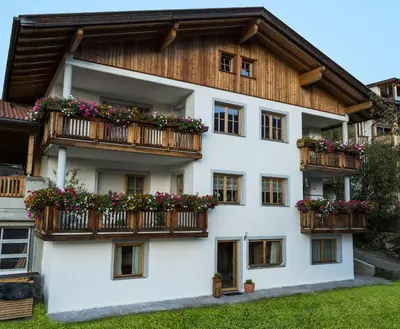 a building with flower boxes on the balconies at Lehrnerhof Lüsen in Luson