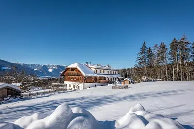 a house on top of a snow covered mountain at Harrerhof in Perca