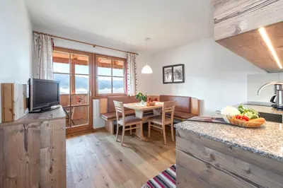 a bedroom with a bed with a wooden ceiling at Harrerhof in Perca