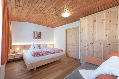 a living room with a table and a red couch at Harrerhof in Perca