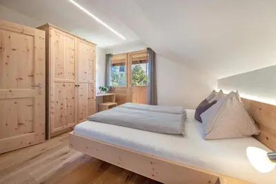 a bedroom with a large bed and a desk at Harrerhof in Perca