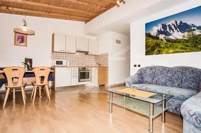 a living room with a couch and a table at Appartements Sonneck in Funes
