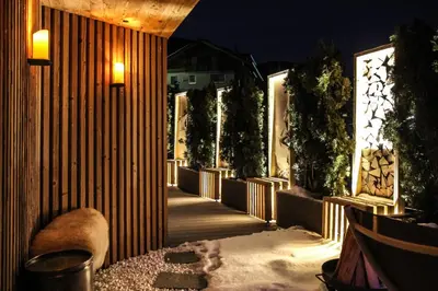 a walkway with a bunch of plants and lights at Appartements Sonneck in Funes