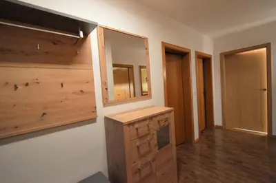 a bathroom with wooden cabinets and a mirror on a wall at Residence Albierch in Ortisei