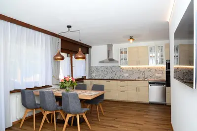 a kitchen with a dining room table and chairs at Residence Albierch in Ortisei