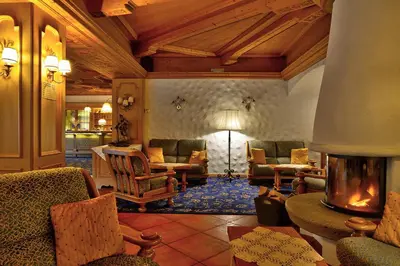 a living room with chairs and a fireplace at Hotel Roy in Malga Ciapela