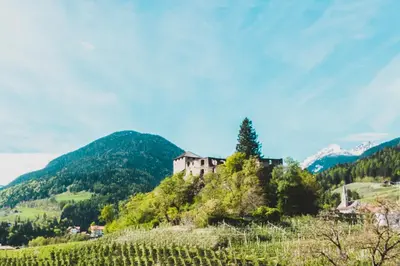 a castle on a hill in the mountains at Falgerhof in Vollan