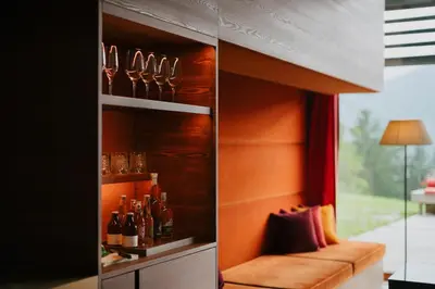 a wine cellar with a bench and wine bottles at Vigilius Mountain Resort in Lana
