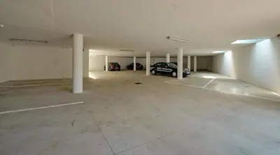 an empty garage with two cars parked in it at Villa Maria in Tirolo