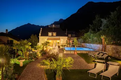 a house with a swimming pool in the yard at Villa Maria in Tirolo