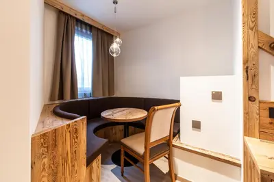 a small room with a table and a couch at Lady Maria Hotel Wellness & Resort in Fondo