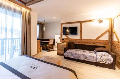 a hotel room with a bed and a table at Lady Maria Hotel Wellness & Resort in Fondo
