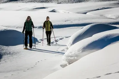 two people cross country skiing in the snow at Alpen Ferienwohnung II in Lappago