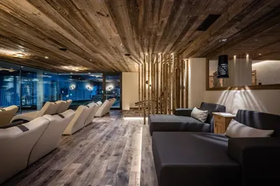 a waiting room with couches and chairs at Hotel Gran Ciasa in Colfosco