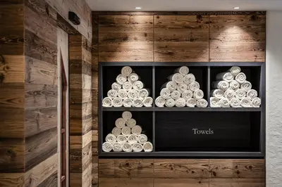 a display cabinet filled with white dishes on display at Hotel Gran Ciasa in Colfosco
