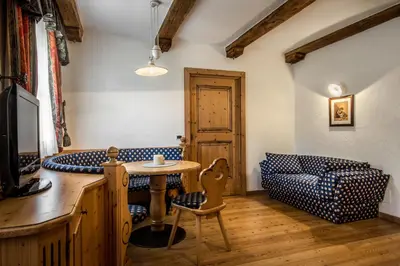 a living room with a table and a couch at Residence Vila in Colfosco